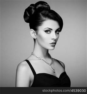 Fashion portrait of young beautiful woman with jewelry and elegant hairstyle. Brunette girl. Perfect make-up. Beauty style woman with diamond accessories. Black and White
