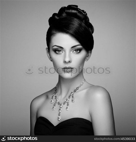Fashion portrait of young beautiful woman with jewelry. Brunette girl. Perfect make-up. Beauty style woman with diamond accessories. Black and White