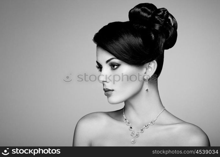 Fashion portrait of young beautiful woman with jewelry. Brunette girl. Perfect make-up. Beauty style woman with diamond accessories. Black and White