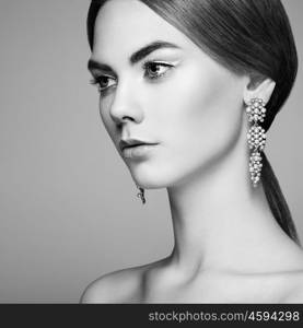 Fashion portrait of young beautiful woman with jewelry. Brunette girl. Perfect make-up. Beauty style woman with diamond accessories. Black and White