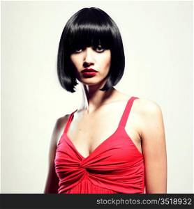Fashion portrait of young beautiful woman with strict hairstyle