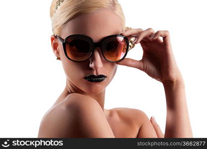 fashion portrait of young blond woman with hair style black lips and wearing gold sunglasses over white