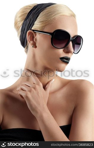 fashion portrait of young blond woman with hair style black lips and wearing sunglasses posing against white background