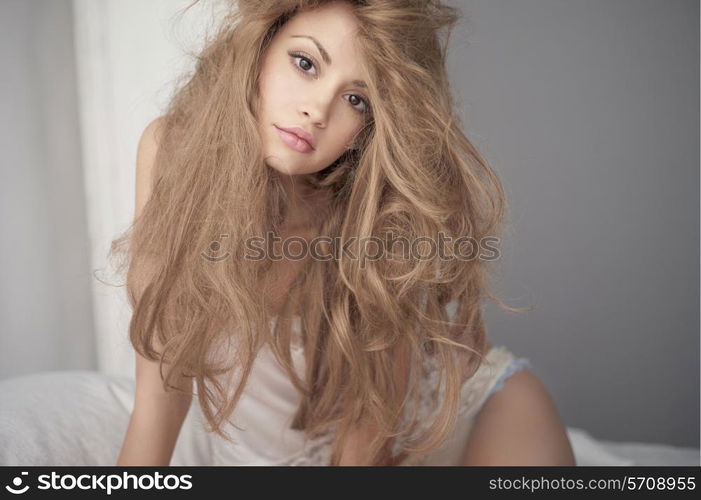 Fashion portrait of young elegant woman in bed