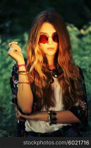 Fashion portrait of young hippie woman in summer sunny day