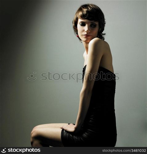 Fashion portrait of young magnificent woman in elegant dress