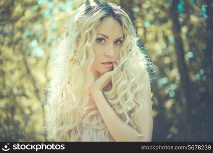 Fashion portrait of young pretty woman in summer sunny day