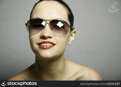 Fashion portrait of young pretty woman with glasses