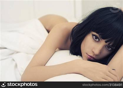 Fashion portrait of young sensual woman in bed