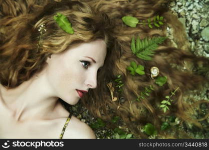 Fashion portrait of young sensual woman in garden