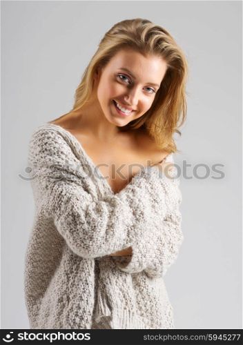 Fashion portrait of young woman on grey background