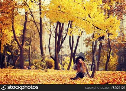 Fashion portrait outdoors young long-haired beautiful model walking in the autumn park.