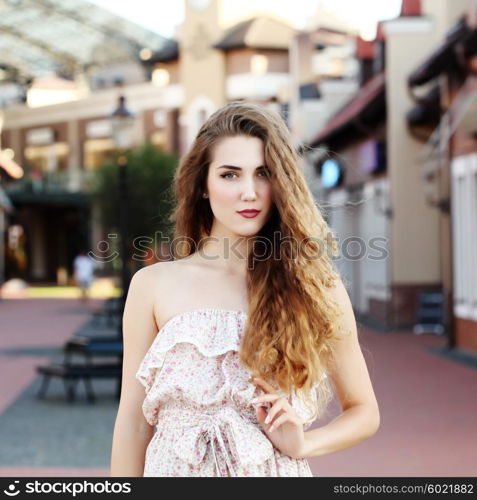 Fashion portraite of a model with long curly healthy hair, ombre