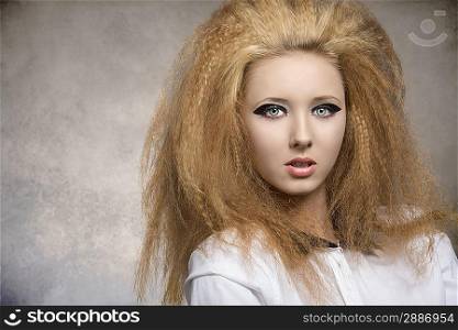 fashion pretty rock girl with dark glossy make-up, creative hair-style in close-up portrait on grunge background