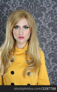 fashion retro blond woman yellow gabardine coat dark wallpaper