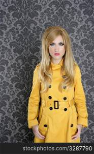 fashion retro blond woman yellow gabardine coat dark wallpaper