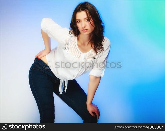 Fashion. Sexy plus size woman in casual clothes, posing studio shot on blue