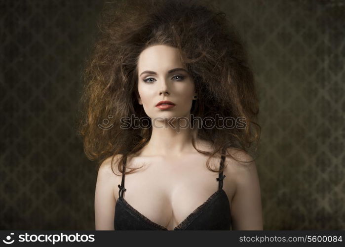 fashion shoot of sensual brunette woman with voluminous creative hair-style, black bra and cute make-up