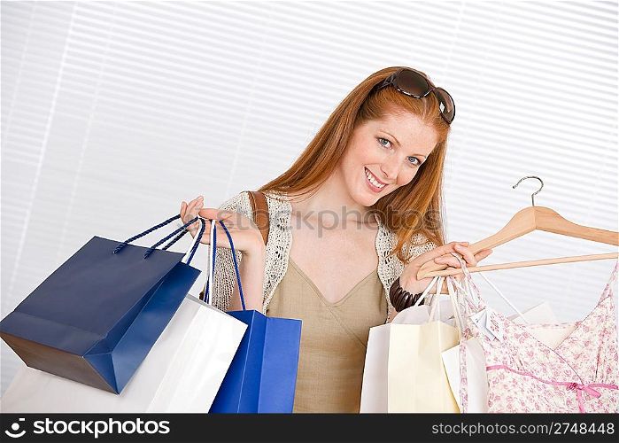 Fashion shopping - Happy woman with bag and sale dress