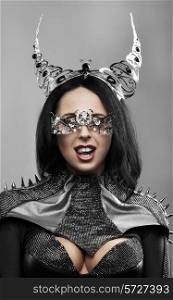 Fashion shot of a woman with metal horns and mask