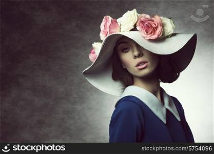 fashion shot of elegant girl with white hat and roses on it , vintage style , spring concept