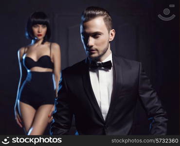 Fashion studio photo of a sensual couple in lingerie and a tuxedo