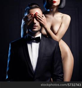 Fashion studio photo of a sensual couple on black background