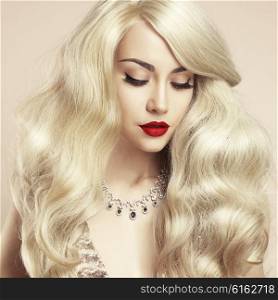 Fashion studio photo of beautiful blonde with magnificent hair. Perfect makeup
