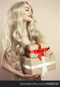 Fashion studio photo of luxury blonde with Christmas gift. Merry Christmas. Happy New Year