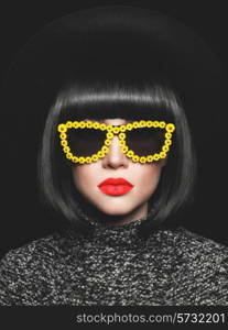 Fashion studio photo of stylish lady in hat and sunglasses