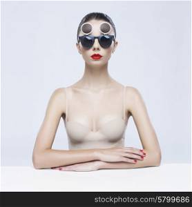 Fashion studio photo of young elegant lady in sunglasses