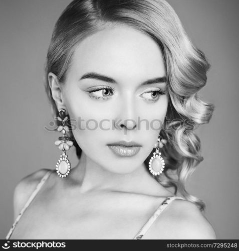 Fashion studio portrait of beautiful blonde woman with classic makeup. Beautiful woman in vintage dress pose in photo-studio. Elegant sexy lady with pretty face and professional hair-dress.