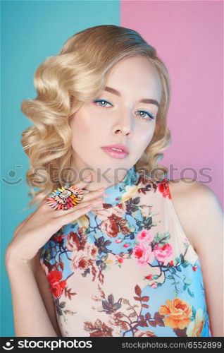 Fashion studio portrait of beautiful blonde woman with color makup on colorful background.  Perfect makeup in pastel shades. Hairstyle Hollywood wave                          