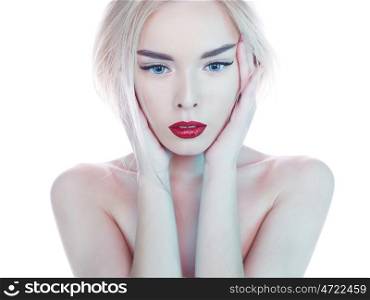 Fashion studio portrait of beautiful blonde woman with perfect makeup. Red lips. Strobing