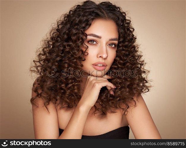 Fashion studio portrait of beautiful smiling woman with afro curls hairstyle. Fashion and beauty