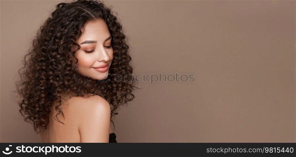 Fashion studio portrait of beautiful smiling woman with afro curly hairstyle. Fashion and beauty