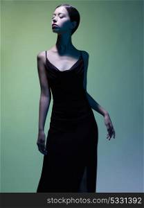 Fashion studio portrait of beautiful woman in black dress on colorful background. Asian beauty.