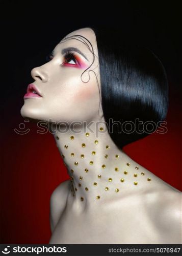 Fashion studio portrait of beautiful woman with bright red makeup. Fashion and Beauty. Perfect makeup