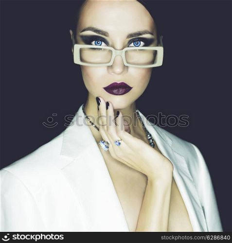 Fashion studio portrait of beautiful woman with glasses