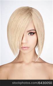 Fashion studio portrait of lovely asian woman with blonde short hair. Fashion and beauty. Bright makeup. Fashionable haircut