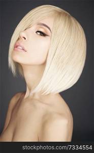 Fashion studio portrait of lovely asian woman with blonde short hair. Fashion and beauty. Bright makeup. Fashionable haircut. Sexy young model with beautiful eyes