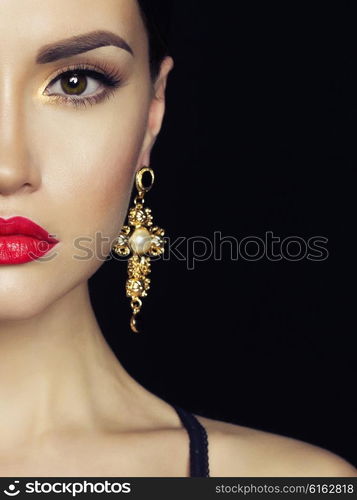 Fashion studio portrait of young beautiful lady with earring on black background