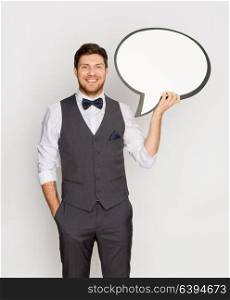 fashion, style and communication concept - happy man in suit holding blank text bubble banner. happy man in suit holding blank text bubble banner