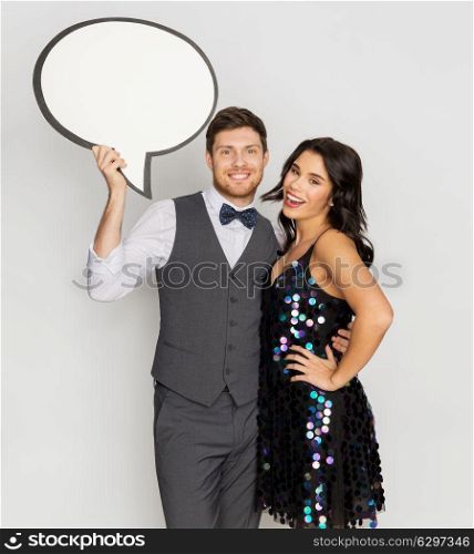fashion, style and holidays concept - happy couple hugging at party and holding blank text bubble banner. happy couple at party holding text bubble banner. happy couple at party holding text bubble banner