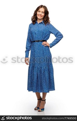 fashion, style and people concept - happy smiling beautiful young woman posing in blue dress over white background. happy smiling beautiful young woman in blue dress