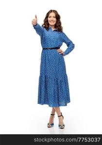 fashion, style and people concept - happy smiling beautiful young woman posing in blue dress showing thumbs up over white background. happy young woman in blue dress showing thumbs up