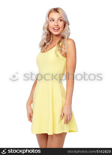 fashion, style and people concept - happy smiling beautiful young woman posing in yellow dress. happy smiling beautiful young woman in dress