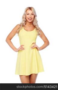 fashion, style and people concept - happy smiling beautiful young woman posing in yellow dress. happy smiling beautiful young woman in dress