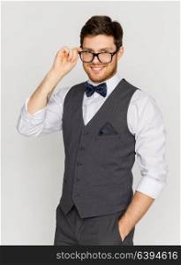 fashion, style and vintage concept - happy man in festive suit and eyeglasses. happy man in festive suit and eyeglasses