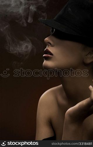fashion style photo of a gorgeous brunette holding a cigarette